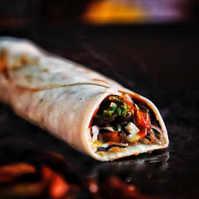 Burrito, with beans, rice, cilantro, and avocado salsa.