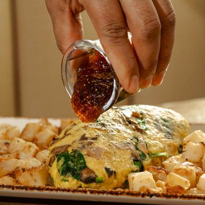 Sweet and Savory Omelet served with breakfast potatoes and fig spread.