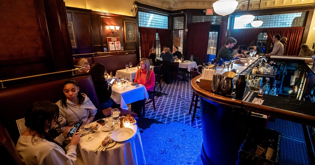 Cozy interior dining area and bar area, guests chatting and enjoying their food and drinks