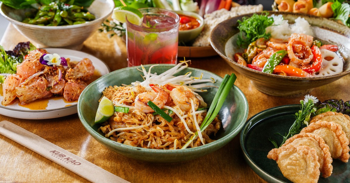 Assortment of dishes served on the table alongside a cocktail