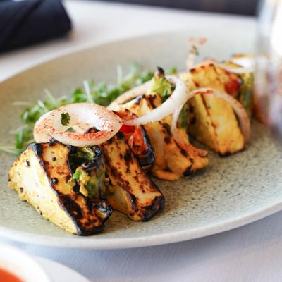 Grilled pineapple pieces topped with onion slices.