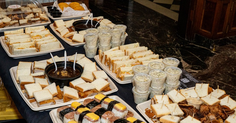 Catering table with sandwiches sushi and dipping cups