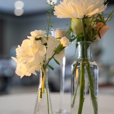 White flowers arranged in clear glass vases.