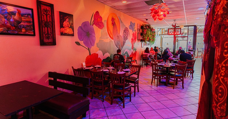 Interior space, dining area with set tables, guests enjoying their food and drinks