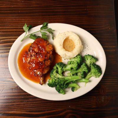 Pork Chop with apricot glaze  with mashed potatoes and broccoli.