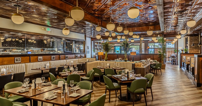 Modern, spacious, and cozy interior dining area with set tables ready for guests
