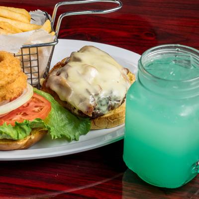Bacon Cheeseburger with a side of fries, alongside a mug of mint lemonade.