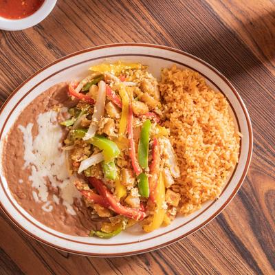 Scrambled eggs, with potatoes, bell peppers, onion, rice, and refried beans.