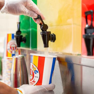 Hands pouring a soda from the dispensary.