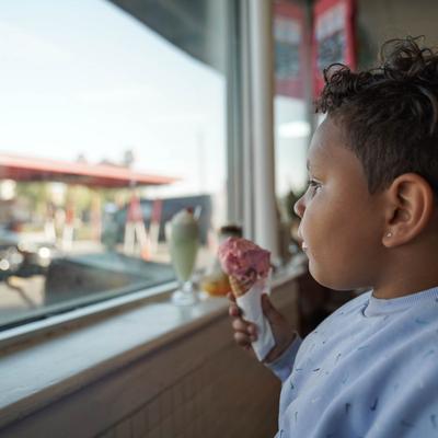 child eating strawberry ice cream cones.