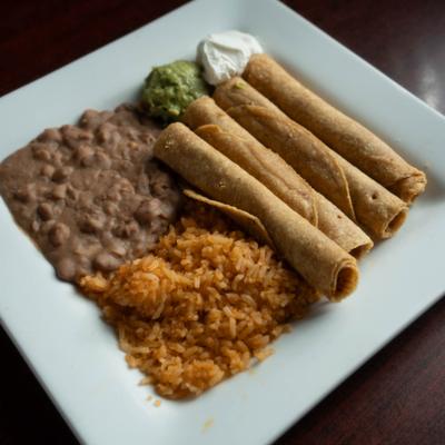 Chicken Flautas Plate served with rice, beans,  guacamol and sour cream.