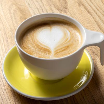 Hot latte featuring a distinct heart-shaped latte art pattern.
