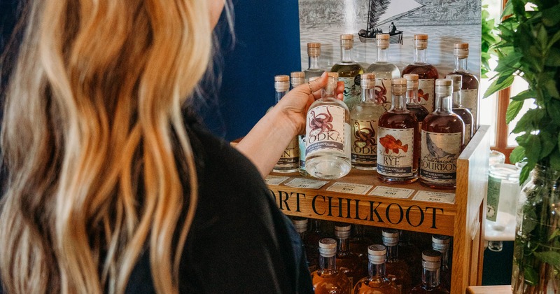 Person browsing liquor bottles on the shelf