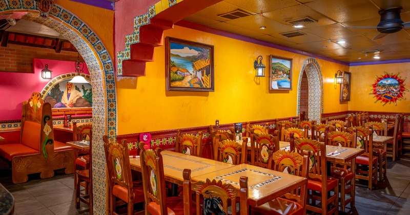 Interior, dining area, wooden top tables for six people, Mexican motif decoration