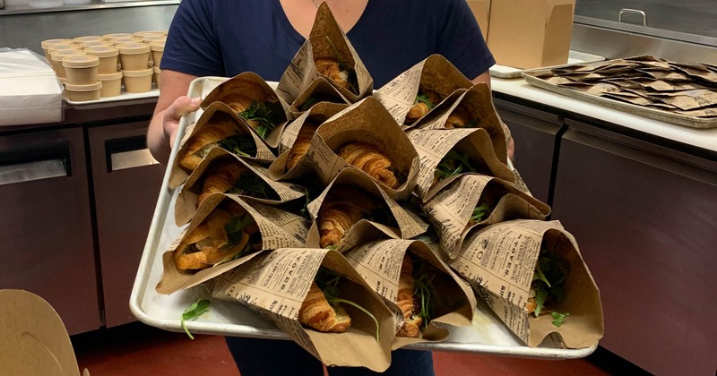Croissant sandwiches packaged in paper bags