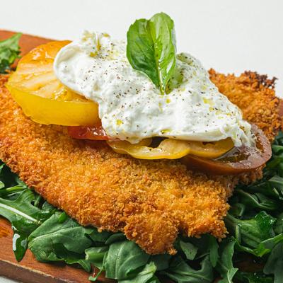 Breaded chicken breast, with arugula, tomato, and burrata.