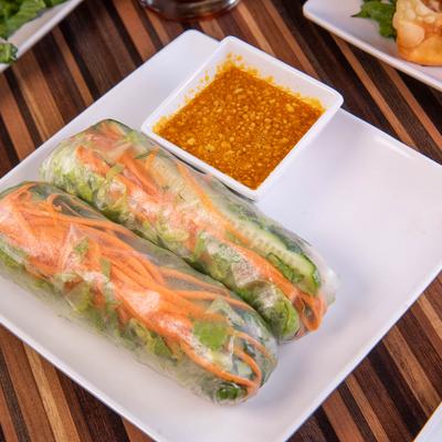 Vietnamese fresh spring rolls with vegetables and peanut dipping sauce.