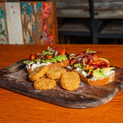 Avocado toast with potato fritters.