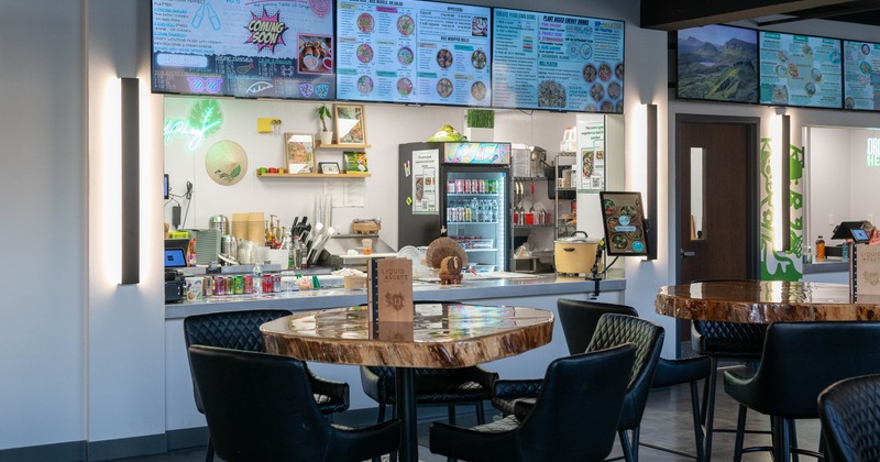 Interior, tables and chairs near bar