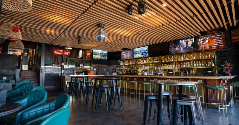 Interior, wide shot of the seating and bar area, tile flooring, hanging disco bowl