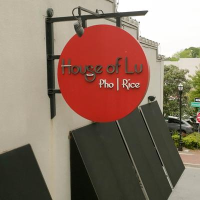 Restaurant sign hanging outside.