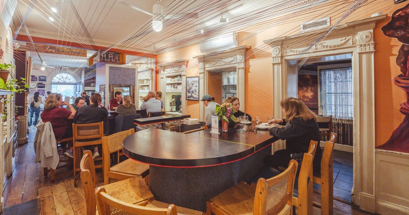 Interior, tables and chairs, guests sitting and chatting