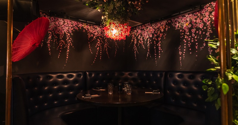 Modern style of interior design, round upholstered booth with a set table ready for guests