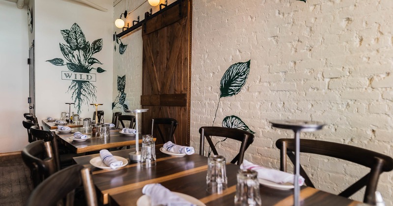 Interior, three tables for four ready for guests