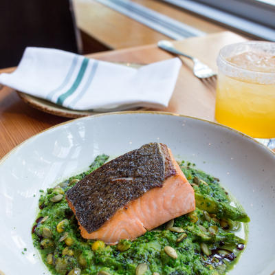 Wild king salmon with a bright yellow cocktail