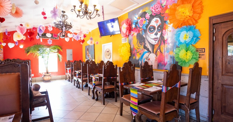 Interior featuring large mural art depicting traditional Mexican cultural themes