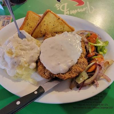 Chicken Fried Steak, with gravy, mashed potatoes, salad, and toast.