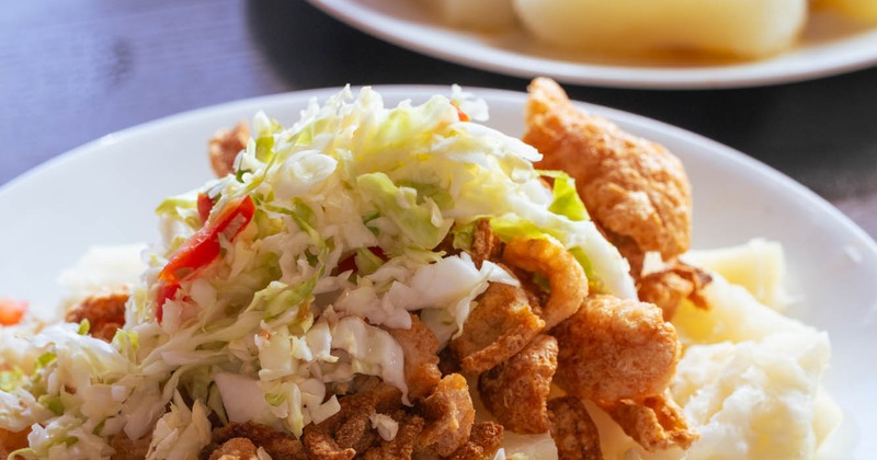Fried pork rinds with yuca and cabbage slaw