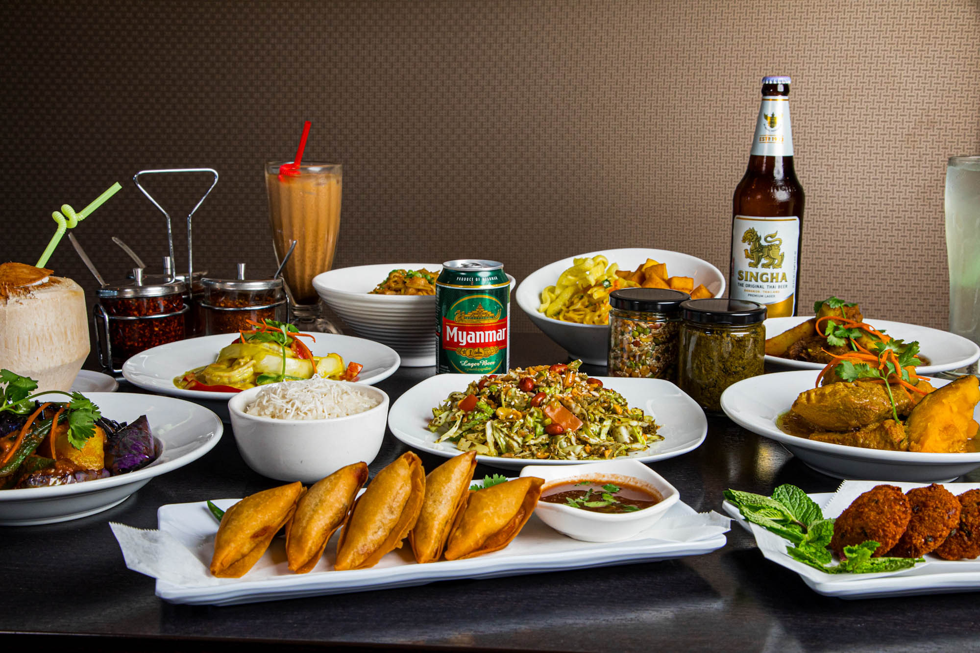 Assortment of food dishes and drinks spread on a table