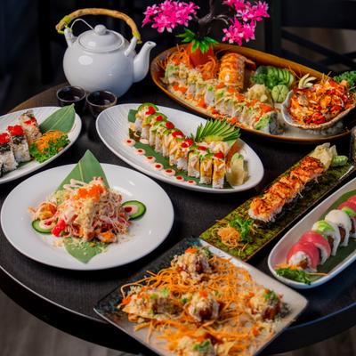 Plates of Sushi on a table.