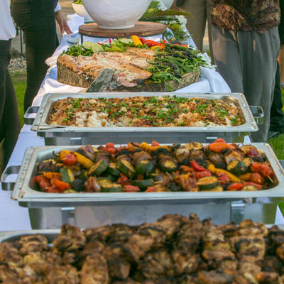 Four dishes and salad lined up, ready for service