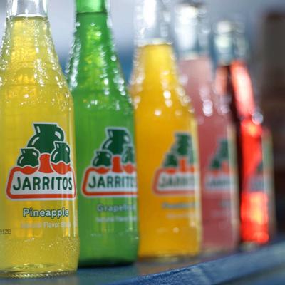 Mexican natural flavor soda bottles display.