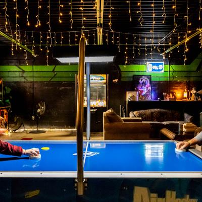 People playing air hockey.