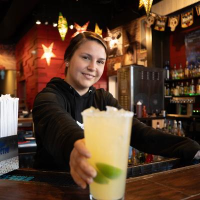 Bartender serving a cocktail.