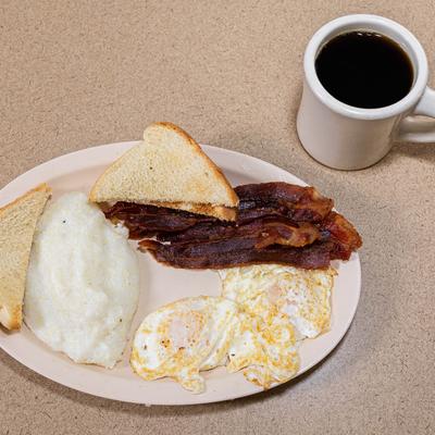 Bacon, fried eggs, gravy, and bread.