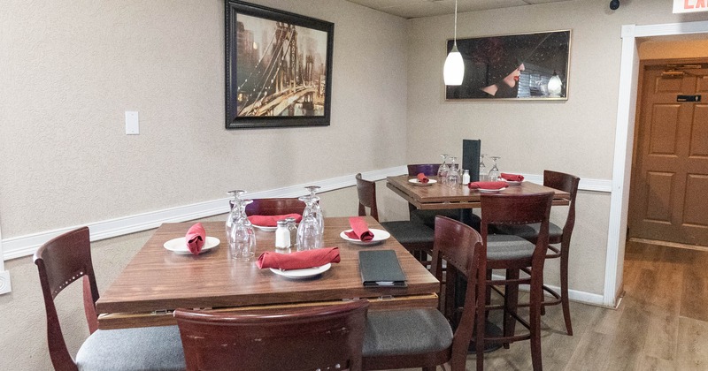 Interior, set tables ready for guests, pictures on the wall