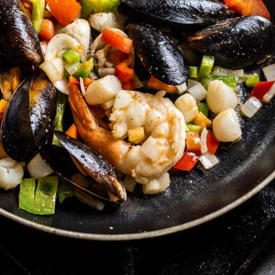 Seafood paella with rice, mussels, shrimp, octopus, chorizo and chicken.