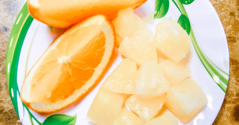 Sliced oranges and pineapples