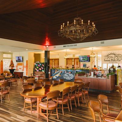 Restaurant interior wooden tables, service counter, and chandeliers.