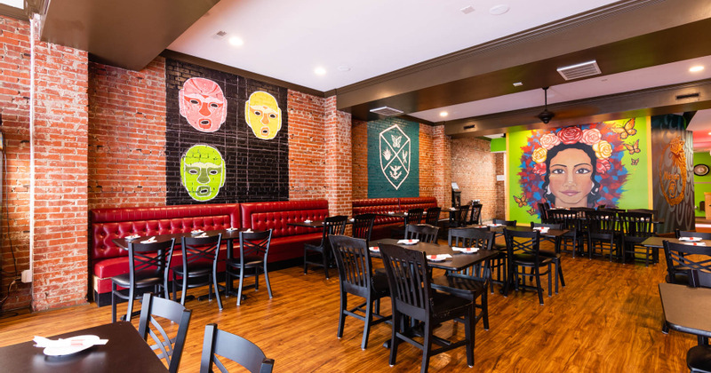 Interior, tables with tableware, seating, mural paintings on the walls