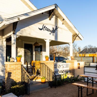 Strangelove restaurant exterior with sunlit front porch seating.