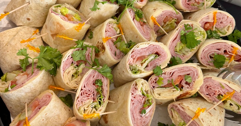 Platter of sliced wrap sandwiches with toothpicks