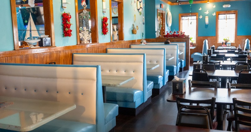 Interior, blue leather seating booths, sky blue walls with decor