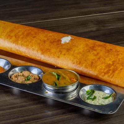 Crispy dosa served with assorted chutneys.