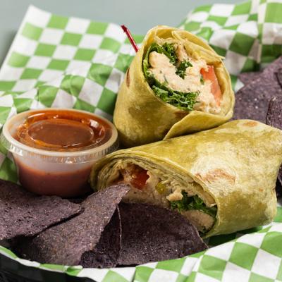 Chikin Salad Wrap served with tortilla chips and a dip.