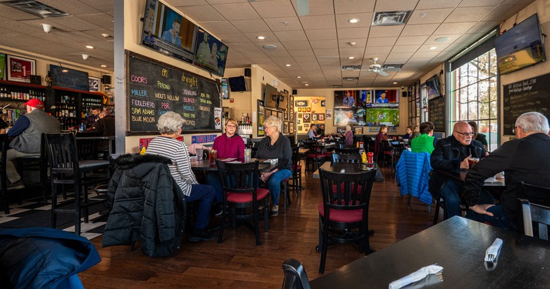 Dining area, black and white tile floor with tables and chairs